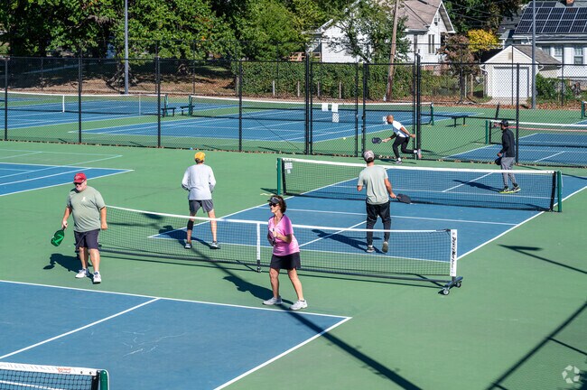 People playing tennis at the Turkey Thicket Recreation Center near Catholic University.