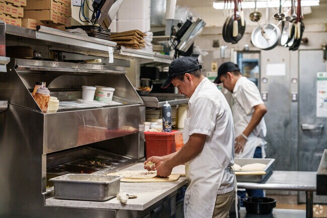 Frederica Pizza and Pasta House cooks work hard to perfect their pizzas.