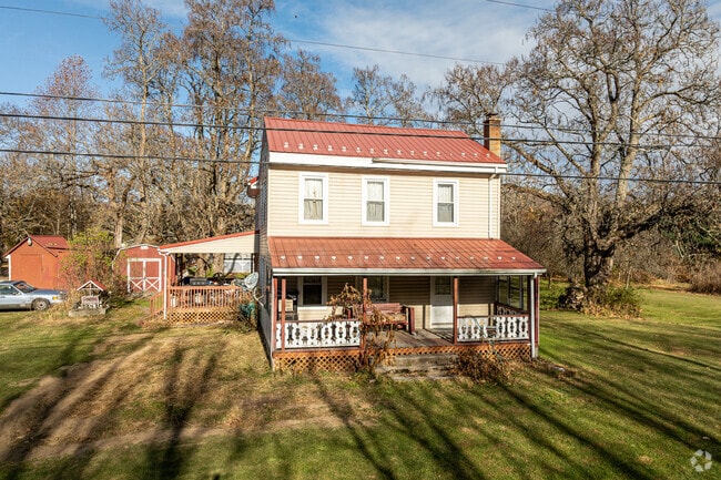 The late afternoon sun shows off this colonial home featuring both front and side porches.
