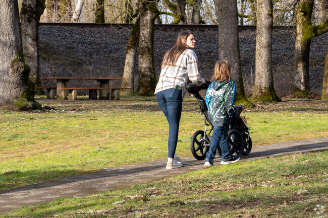 Families enjoy the paved walking paths at Fairview Community Park.
