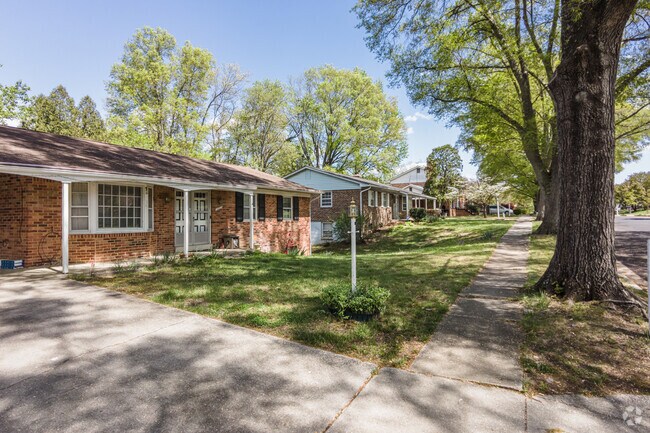 Brick ranch homes with porches and large trees in Rosaryville.
