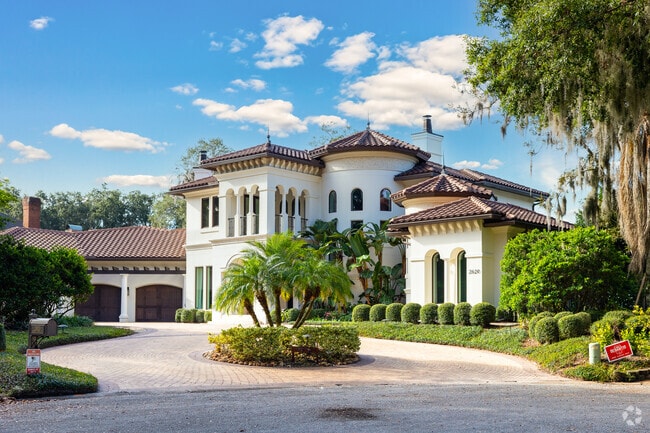 Modern Spanish revival home with a large driveway and spacious garden in Beauclerc.