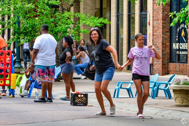 A mom and daughter do some dancing together at Zoo After Hours in the Central Business District.