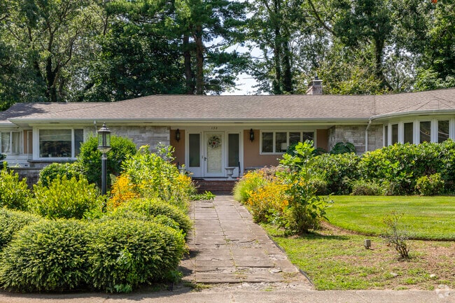Lush landscaping line the walkway up to this beautiful ranch home in Brockton Heights.