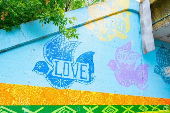 A vibrant mural from the King of Peace series, painted by local students, adds color and meaning to the Chicago Lawn community.