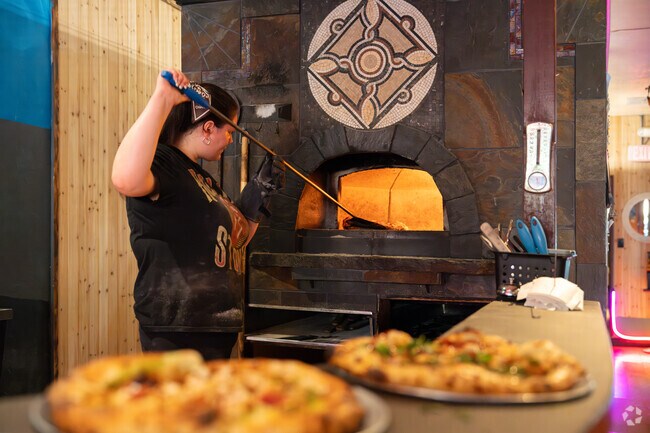 Locals enjoy the wood-fired pies at Pizzario on Main Street.