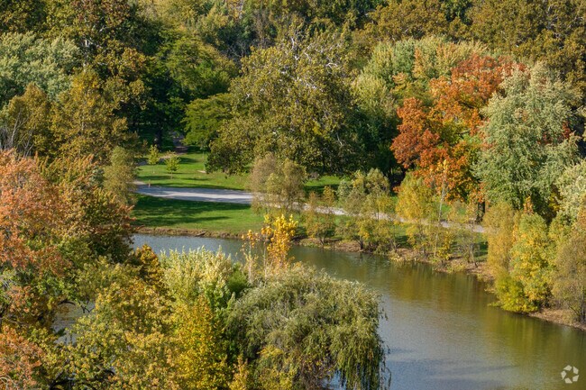 Vibrant fall leaves create a breathtaking reflection along Swinney Park's pond in Fort Wayne.