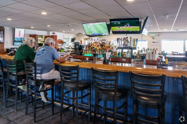 Friends enjoy a drink together in the bar at Dock of the Bay in Edgemere.