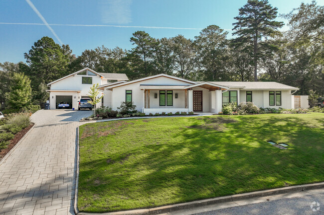 Farmhouse style homes in Cloverleaf line streets with long driveways and detached car garages.
