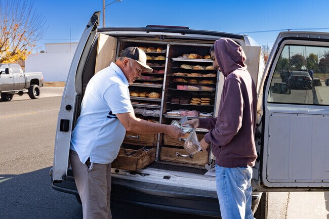 A local vendor in West Delano delivers fresh bread and pastries to local residents.