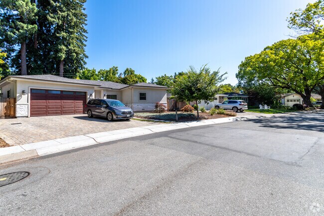 On a gently curved street in Linfield Oaks, a spacious ranch-style home stands proudly.