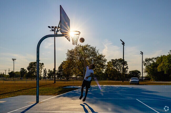 Locals can practice their free throws or layups at Boland Park's basketball courts.