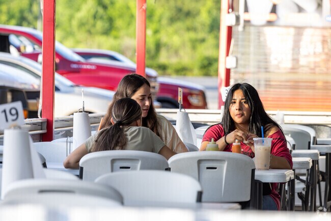 Friends share a meal at The Food Zone just down the road from The Highlands.