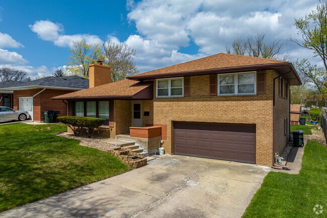 An uncommon home style in Homewood, a bi-level home style sitting on a hill.