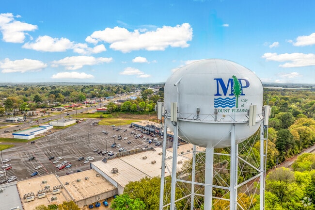 Experience the charm of Mount Pleasant from an aerial view near the iconic water tower, overlooking the bustling shopping district along Highway 271.