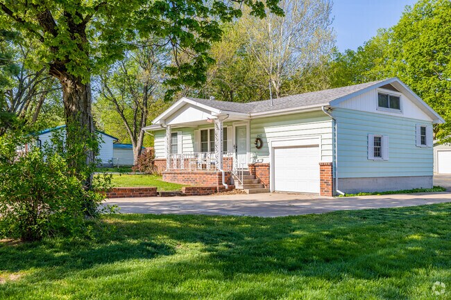 A minimal traditional style home in the Doling Park neighborhood surrounded by trees.