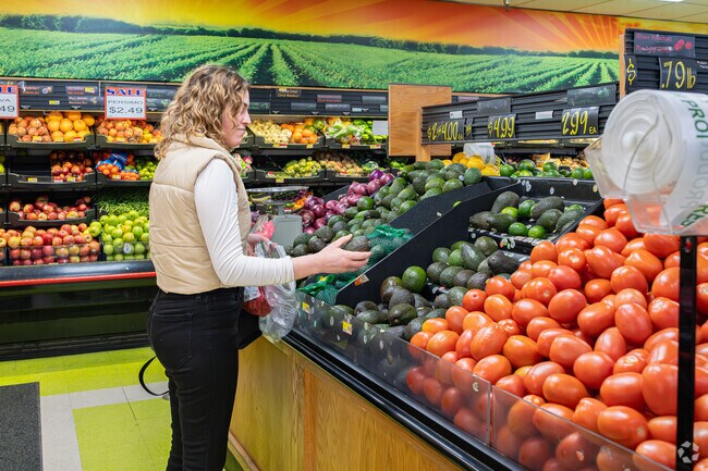A young Avenal residents looks for the ripest avocado at State Foods Supermarket.