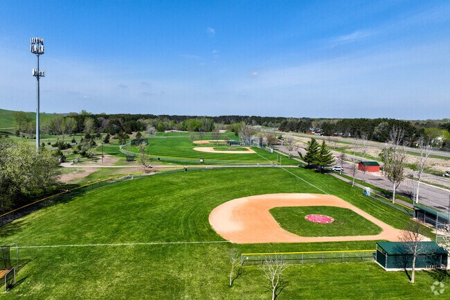 Alpine Park is an expansive city park with four baseball fields, a soccer field, playground, and fenced dog play area.