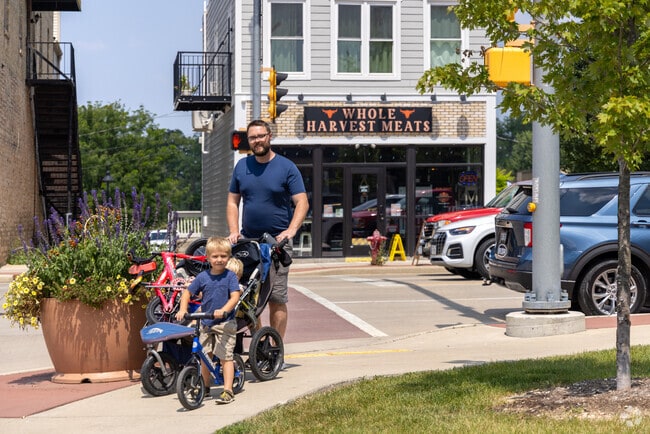 A family strolls by Corner Park in the heart of downtown Waterford.