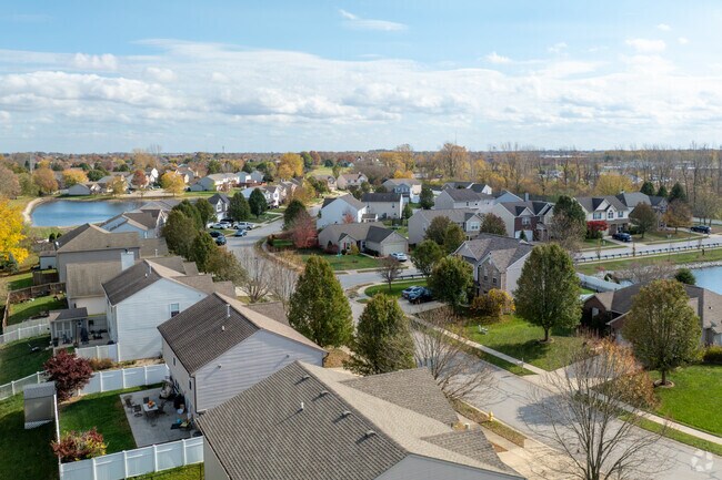 Rows of homes in Greenwood are framed by the rich hues of fall