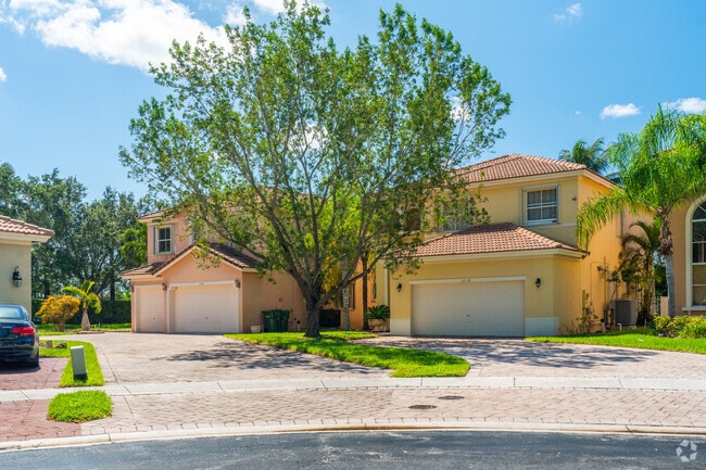 Waterstone homes feature car garages and Spanish design elements.