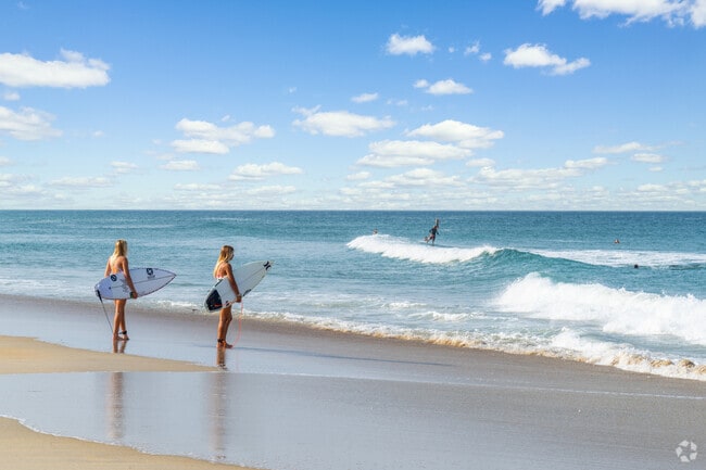 Surfers size up the break on Whalebone Beach.