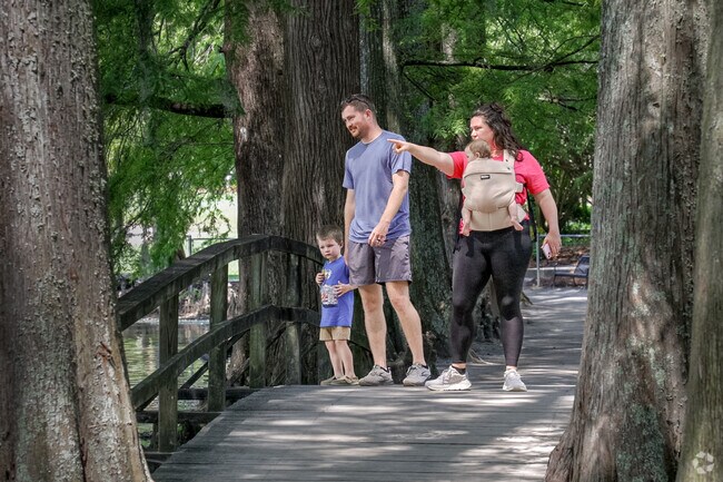 The families enjoy a leisurely stroll at the Swan Lake Iris Gardens park.