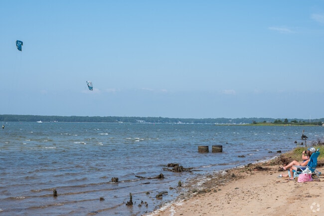 Waquoit beach goers watch kite surfers from Callies Beach.