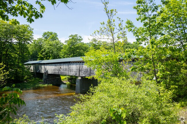 Brookline's historic Scott Covered Bridge, built in 1870 and open to pedestrians only, is a timeless landmark, blending history and craftsmanship in a tranquil riverside setting.