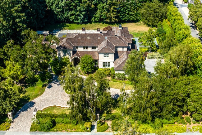 A stunning 20th-century home nestled amidst lush trees in Atherton.