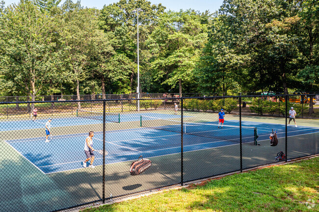 Playing a competitive couples game of tennis in Bicentennial Park located in East Brunswick, NJ.