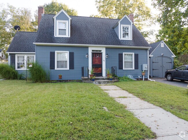 A well designed cape cod with a matching garage.