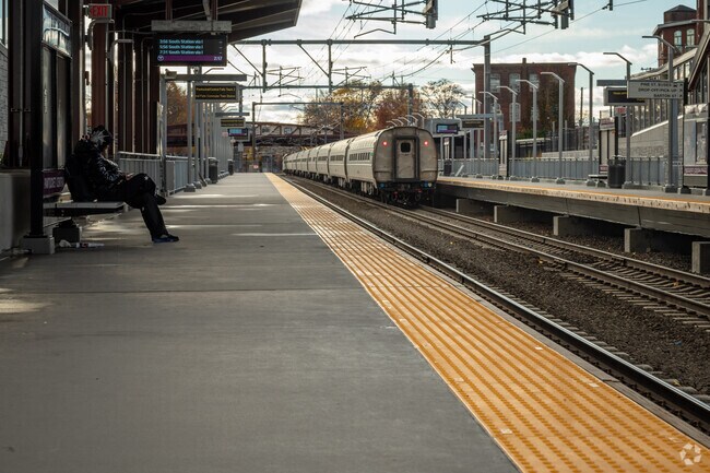 A young man waiting for the next train at the Pawtucket-Central Falls Commuter Rail Station.