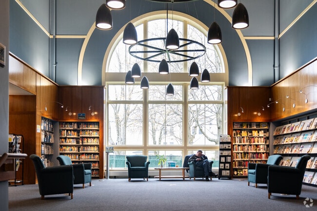 A visitor enjoys a quiet moment at Parker Memorial Library in Dracut.