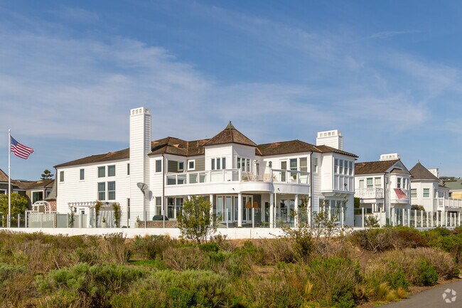 The Cape Cod-style homes in Castaways showcase charming shingle siding, white trim, and classic dormer windows, blending East Coast elegance with coastal luxury.