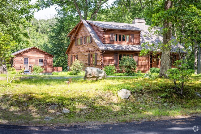 The rustic nature of the Nichols Corner neighborhood is mirrored by this log cabin style home.