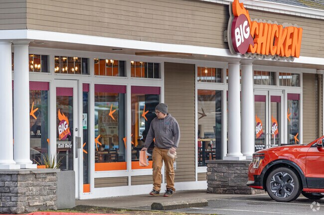 A pedestrian enjoys one of many fast-food spots in Harbour Pointe area.