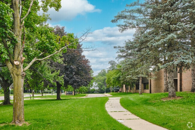 A concrete pathway runs around Estabrook Elementary and connects the entrances to parking.