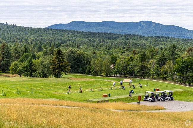 The driving range at the Baker Hill Golf Club overlooks Mount Sunapee in the background.