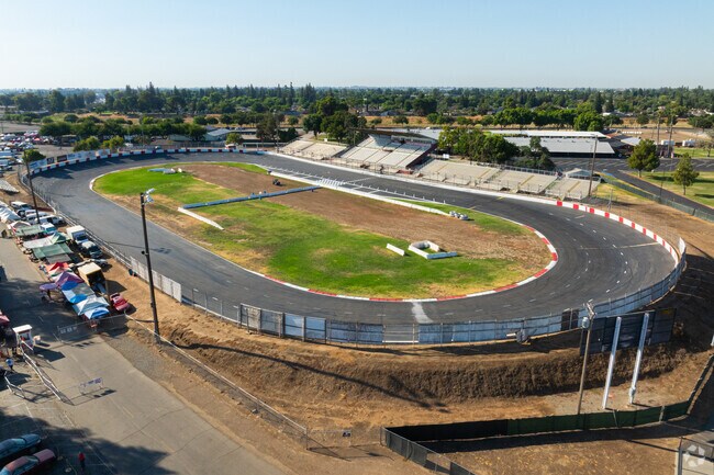 Spectators cheer for race cars at the Madera Speedway track in North Madera.