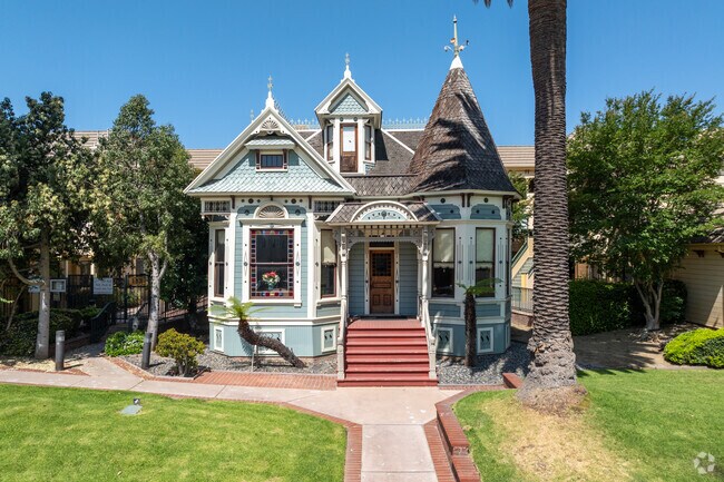 The Victorian-style home in Citrus Grove stands out with its intricate woodwork and ornate trim detailing along the eaves and porch.