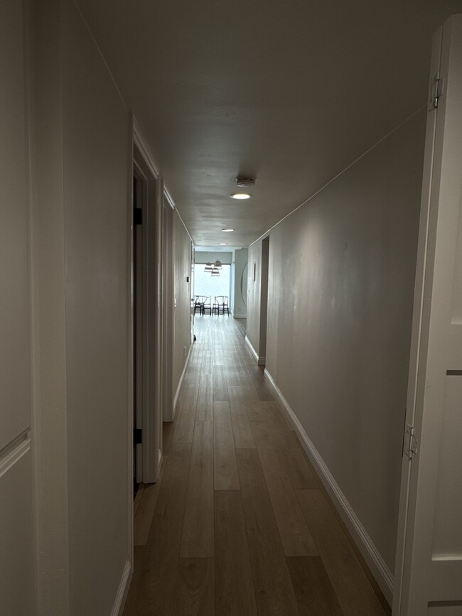 Hallway facing south towards living room and kitchen
