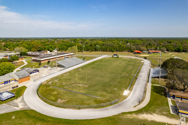 Students shine in front of their parents play football on the fields at Lake Weir High School.