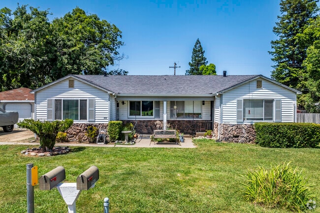 This bungalow style home has rock accents and simple landscaping in Carmichael.