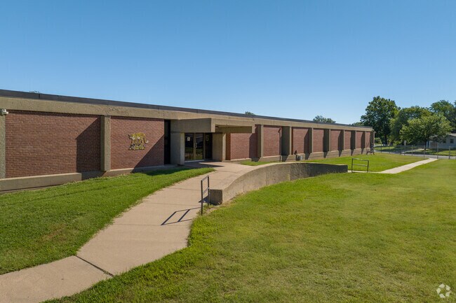 There are several sidewalks surrounding Kensler Elementary School.