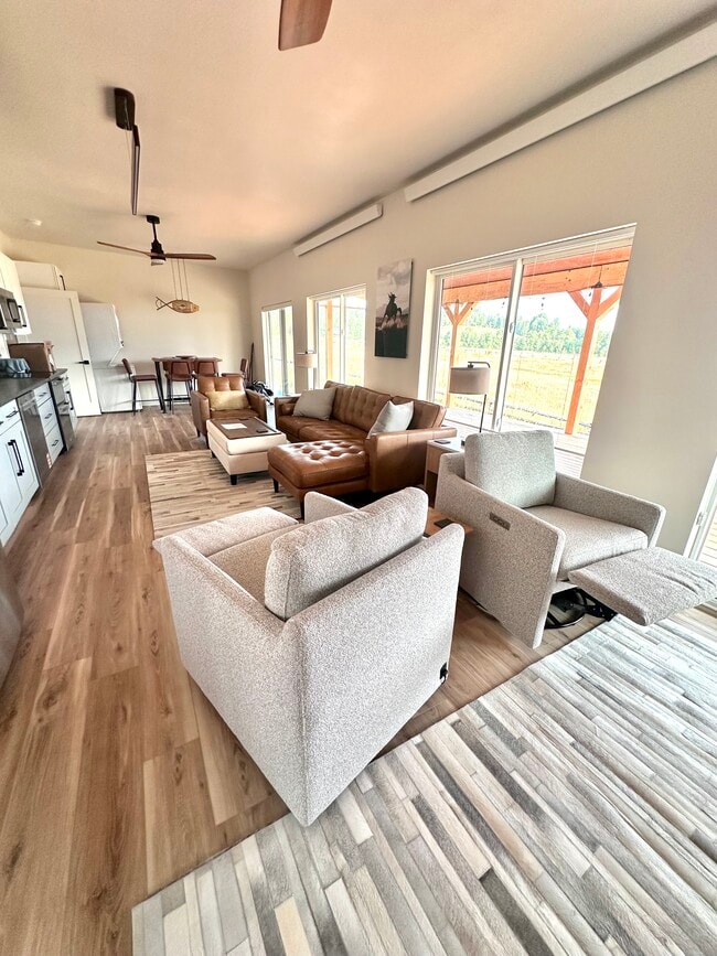 Recliners in front of large TV and fireplace also swivel to kitchen fun.