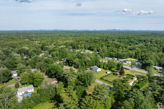 Dense forest and distant mountains surround the quite town of Milford.