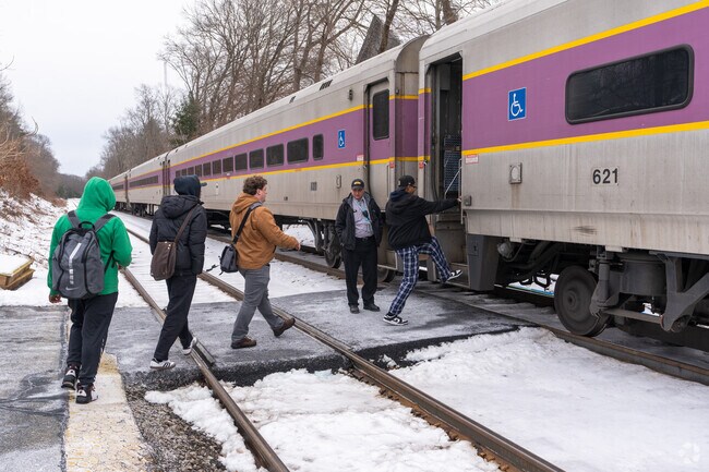 Folks at Lincoln Station board a commuter rail train bound for North Station.