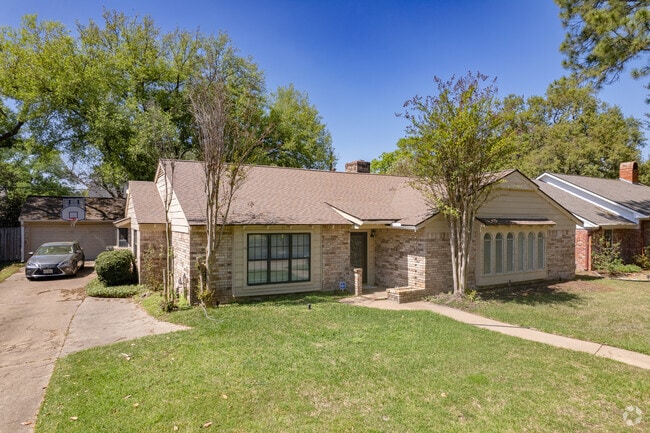 A one-story, Ranch-style home with a covered entrance in the Spring Shadows neighborhood.