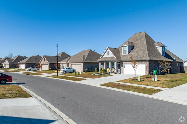 A row of brick homes adorn a quiet road in Prairieville.
